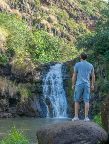 Visitor admiring Waimea Falls on the North Shore of Oʻahu