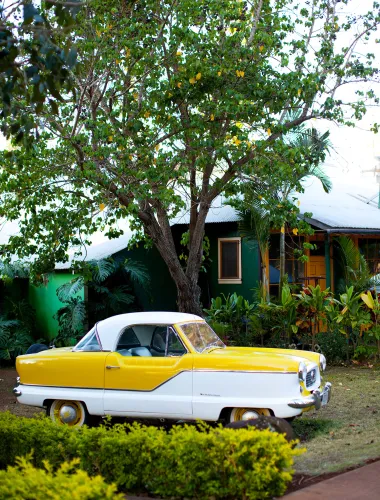 Old car parked in front of Dis ‘N Dat Shop in Lānaʻi City in Hawaiʻi