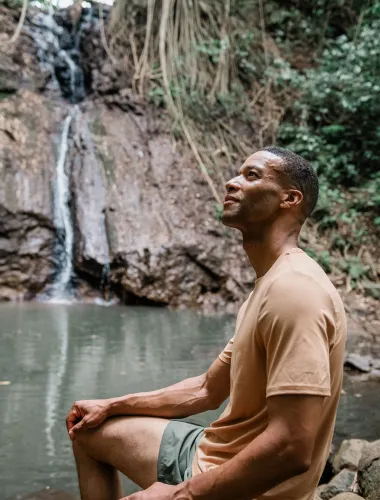 Man at waterfall near Līhuʻe on Kauaʻi in Hawaiʻi
