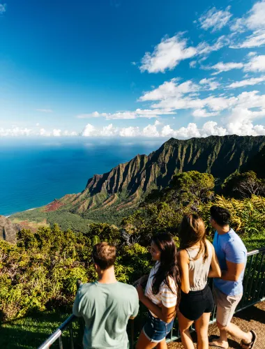 Visitors at Kalalau Valley Lookout in the Kōke‘e State Park view Kalalau Valley, one of the valleys that sit along Kaua‘i’s Nāpali Coast.