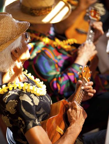 People playing ukuleles at a Molokai event