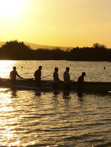Outrigger canoeing at sunset off the Hawaiian island of Molokai