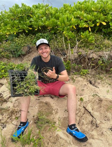 North Shore Stables man helping plant