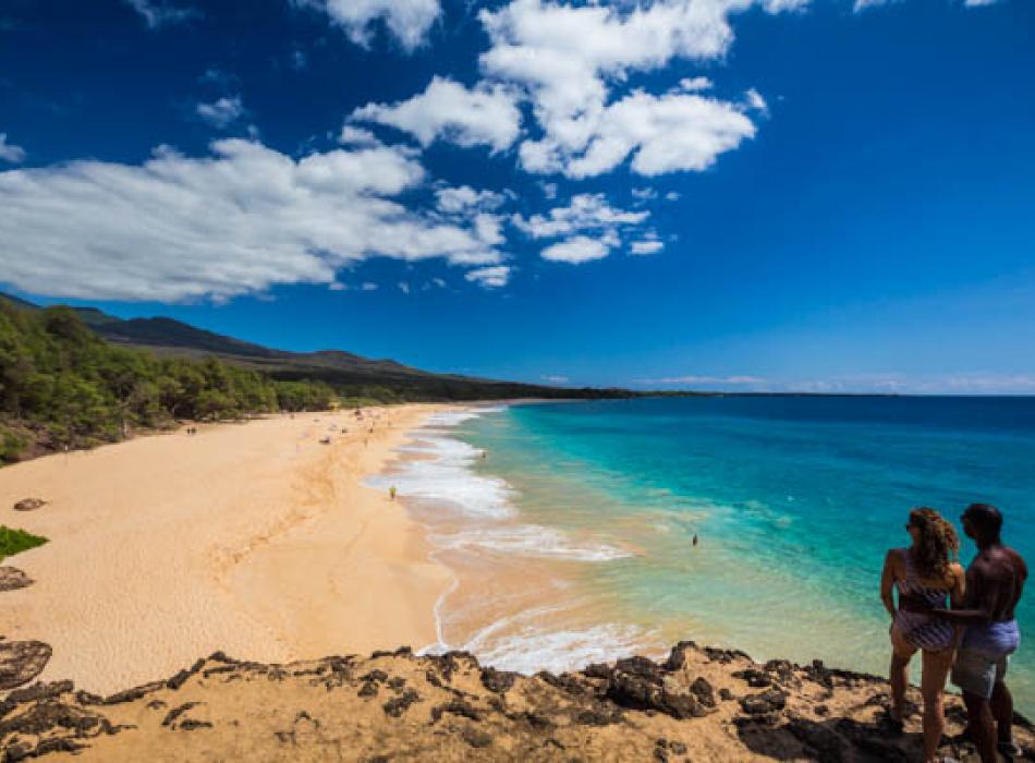 A couple enjoying the view on a beach on Maui