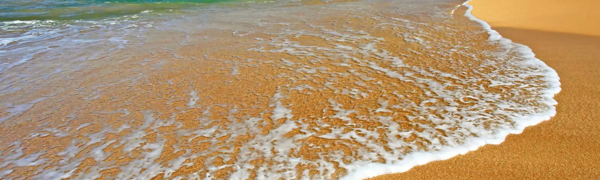 Waves crashing onto a sandy beach
