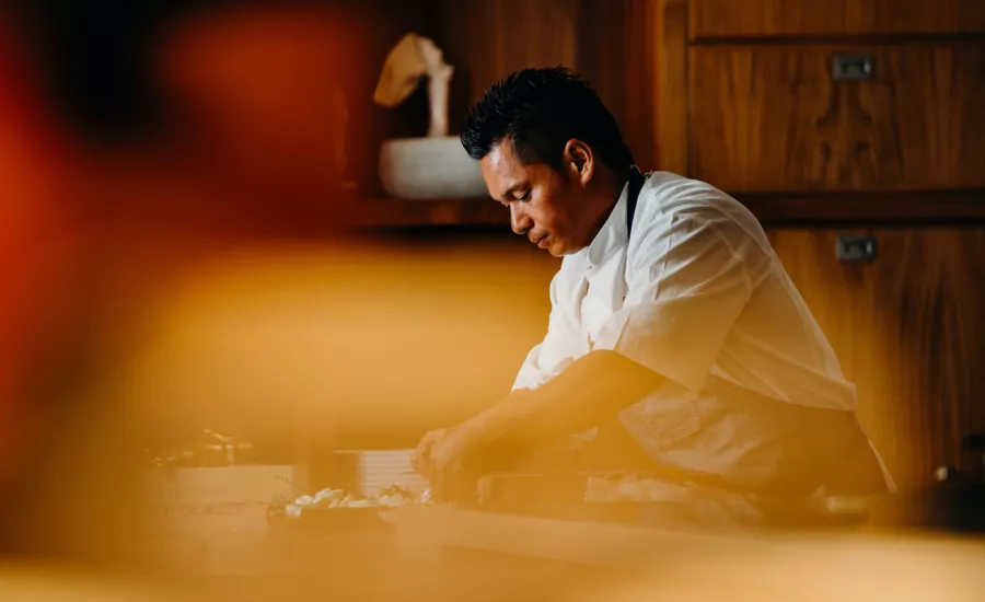 Chef prepares a fresh fish dish